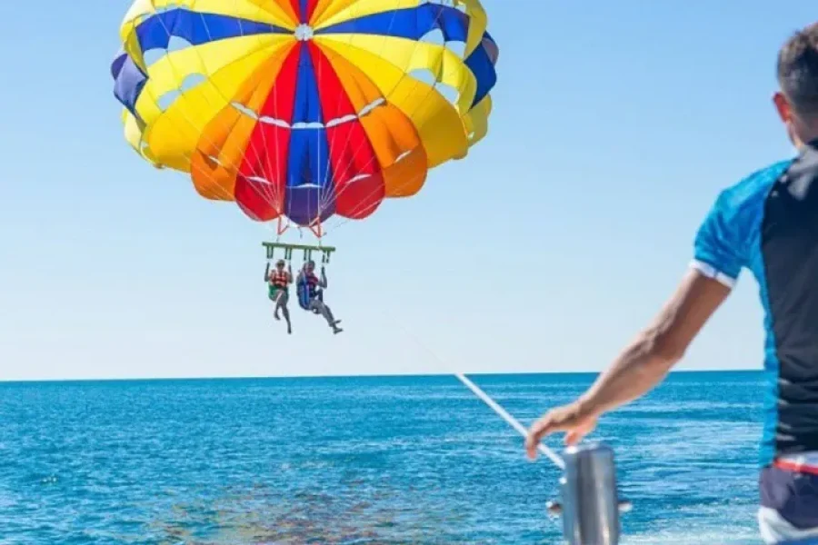 Person parasailing high above the Red Sea during a Hurghada parasailing adventure
