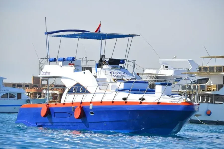 Family enjoying a private boat trip with fishing, snorkeling, island hopping, and lunch in Hurghada